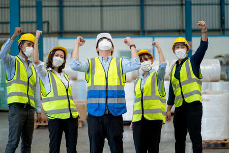 Group of warehouse worker with uniform and hygiene express happiness emotion and stand together in workplace.の写真素材
