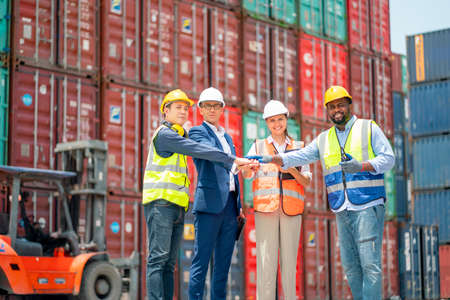 Group of cargo container worker or technician clasp one's hands or join hands together also look at...