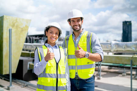 Portrait of two professional engineer or technician workers stand and look at camera with smiling...