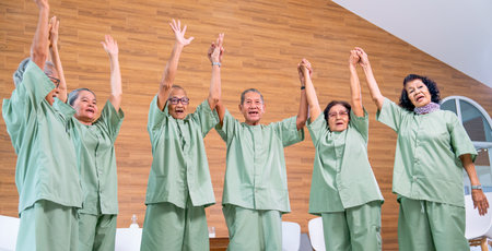 Asian senior men and women raise their hands up and express of happiness together with concept of good health and cheerful for eldery society.の写真素材