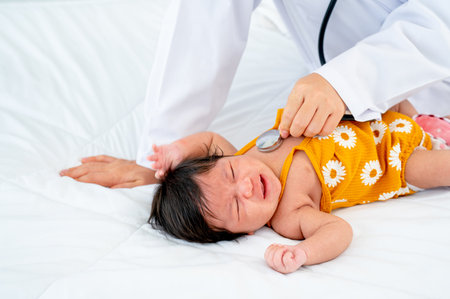 The doctor use stethoscope to check the symptom of newborn baby cry and lie on bed in room with day...