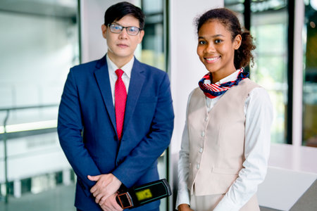 Portrait and close up of air hostess and airline staff at gate of airport to welcome and check the...