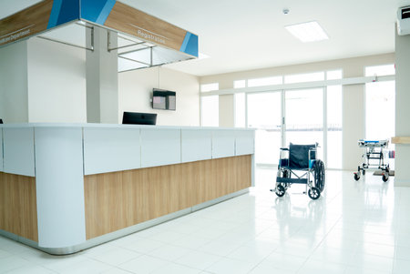 Empty room in area of reception or registration counter in hospital with wheelchair or mobilebed to support healthcare and treatment for patient.の写真素材
