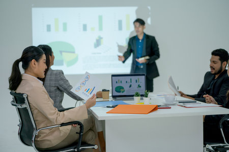 Business man and woman concentrate to the presentation of business man in meeting room.の写真素材