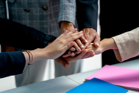 Close up business man and woman join hands together to express cooperate for work to get successful in office.の写真素材