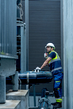 Vertical image of engineer or technician worker hold  walkie talkie and stand with looking and...