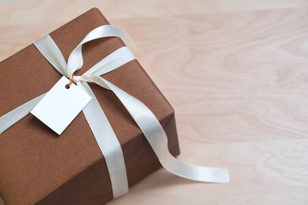 Gift Box on wood talbe with blank card, copy spaceの写真素材