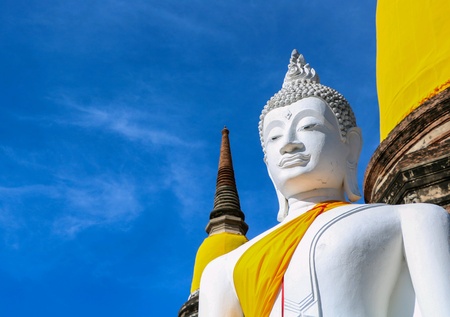 White Buddha statue with blue skyの素材