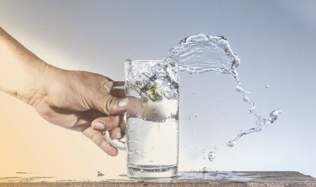 A glass of water spilled Splash on the table
