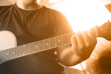 Men's black shirt, living acoustic guitarの写真素材