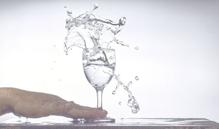 A glass of water spilled 
Splash on the tableの写真素材