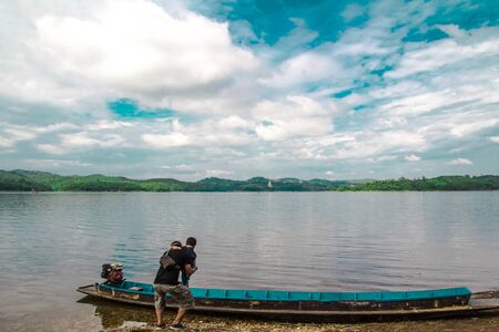 Father holding baby up on the shore.の写真素材