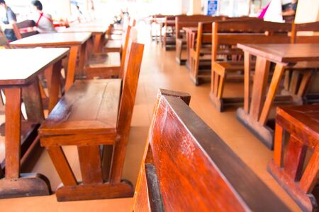 Wooden tables and chairs placed by the restaurant.の写真素材