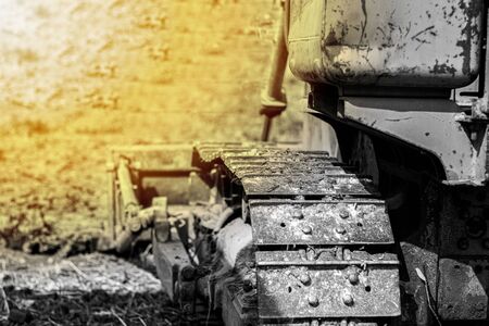 Old yellow-tone tracked tractors, heavy-dutyの写真素材