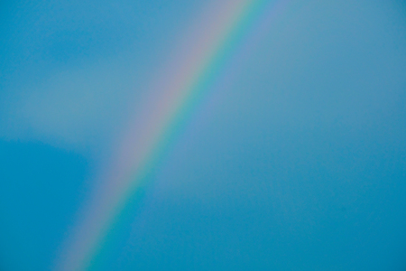 Rainbow and blue sky backgroundの写真素材