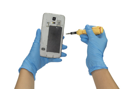 Gloved hand holding a smart phone. To make repairs.の写真素材