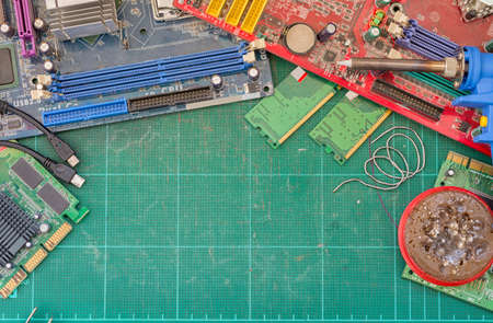 close-up of electronic circuit board with soldering iron