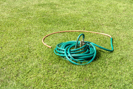 Old Rubber tube with aged on grass in gardenの写真素材