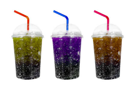 Lemon, Purple and Cola soda with ice in plastic grass isolated on white backgroundの写真素材