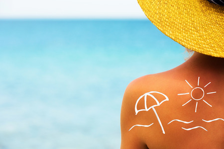 Suncream on back of woman shoulder の写真素材
