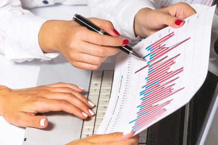 Female hands doing research, at business meeting の写真素材