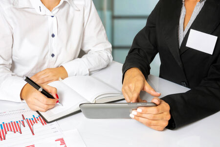 Business women doing business research, in the bright office の写真素材