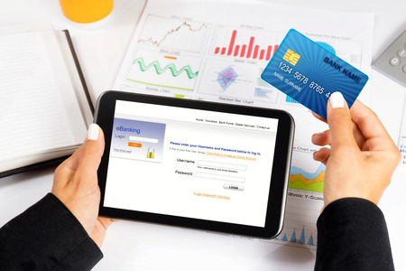 Female hand,using internet card for e-banking.の写真素材