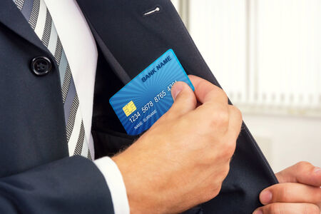 Close up of a businessman getting credit card from his pocket の写真素材