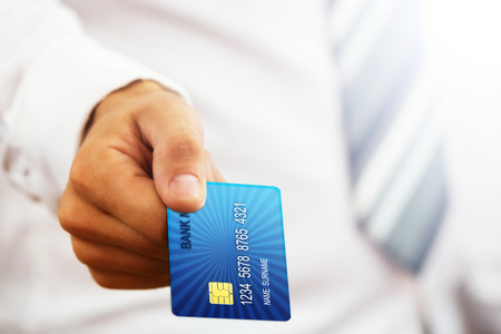 Close up of a businessman s hand,holding blue credit card の写真素材