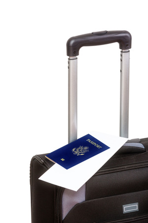 Close up of a black suitcase with passport on top, isolated on white background の写真素材
