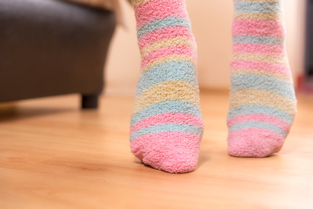 Close up of a person walking on its tip toes, inside bedroom の写真素材