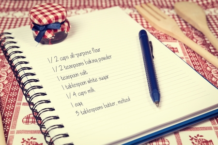 Recipe book on kitchen table の写真素材