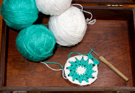 Several balls for crochet lace , in wooden box.の写真素材
