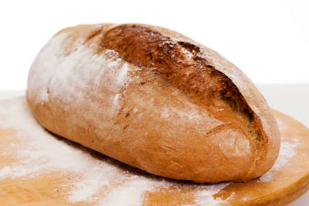 Homemade bread on wooden board, on table.の写真素材
