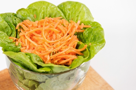 Lettuce and carrot salad in glass bowl.の写真素材