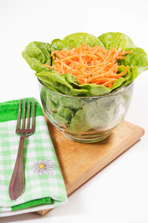 Lettuce and carrot salad in glass bowl.の写真素材