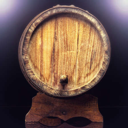 Old wooden barrel isolated on dark .の写真素材