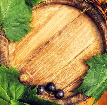 Top view of the old wooden barrel, and grapes on it.の写真素材