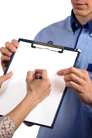Close up of woman\'s hands receiving post and signing document.の写真素材