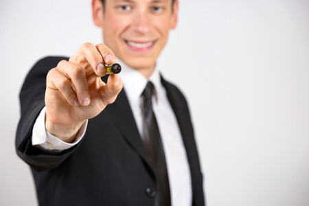 Happy businessman writing or drawing with marker on screen.の写真素材