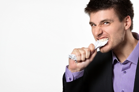 Frustrated young business man,isolated on gray background.