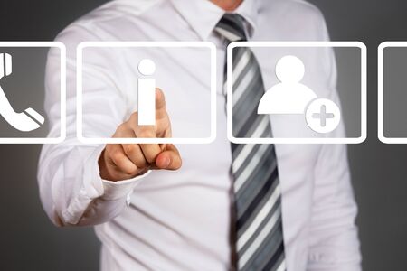 New technology concept. Businessman touching display. White, simple info, contact, headphone icons.の写真素材