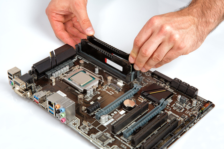 Modern computer mother board assembly, memory installation.の写真素材