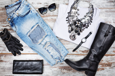 Casual woman out fit. Woman clothes and accessories, on top of the wooden table.の写真素材
