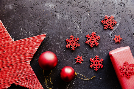 Close-up of red Christmas decorative elements against dark background.の写真素材