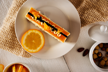 White creamy piece of cake with orange flavor shot from above.の写真素材