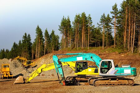 Group of earth moving construction machines, at construction site.の写真素材