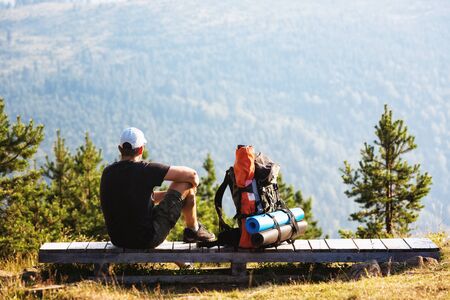 Male hiker enjoying the view of the nearby mountains.の写真素材