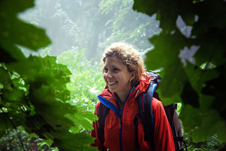 Close up of smiling female hiker in the rainforest.の写真素材