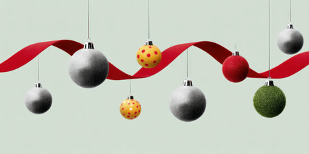 Silver gray red and green Christmas ornament balls suspended with red ribbon add festive joyful holiday cheerの素材